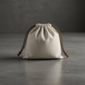 A small, beige drawstring pouch with a simple, rustic design. It is made of fabric and Royalty Free Stock Photo