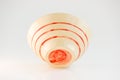 Small beige plate with red stripes. handwork. made on a potter s wheel, covered with transparent glaze, burned in a kiln