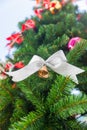 Small bell with white ribbon ornament on Christmas Tree Royalty Free Stock Photo