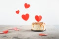 Small bento cheesecake decorated with small hearts topper. Valentine`s day concept