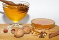 Small and big bowls with dark and light colored honey on wooden table