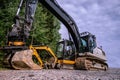 Small and big excavators at a construction site low angle view Royalty Free Stock Photo