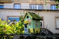 Small bird house on a stone fence with funny inscription Royalty Free Stock Photo