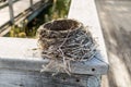 Small Straw Robin's Nest on Wooden Banister