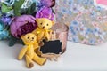 Cute beautiful decor, a small black Board for notes, two yellow textile bears and a bouquet of flowers in a vase Royalty Free Stock Photo