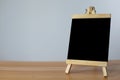 Small black board on wooden table,blank blackboard isolated