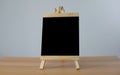 Small black board on wooden table,blank blackboard isolated Royalty Free Stock Photo