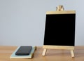Small black board on wooden table,blank blackboard isolated Royalty Free Stock Photo