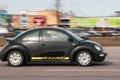 A small black car is driving down the street. Volkswagen Beetle. Motion blur. Riga, Latvia - 06 Apr 2022