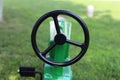 A small black John Deere tractor steering wheel