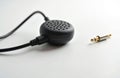 Small black lapel microphone with cable and audio jack. Device for voice recording on white background. This tech captures sound Royalty Free Stock Photo