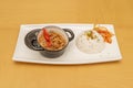 small black pie with Filipino bicol express stew with white rice