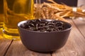 Small black pretzels in a bowl with glass ob beer on the wooden table Royalty Free Stock Photo