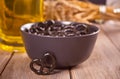 Small black pretzels in a bowl with glass ob beer on the wooden table Royalty Free Stock Photo