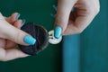 A small black purse and a coin in the hands of a girl Royalty Free Stock Photo