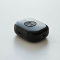 A small, black, rectangular electronic device with rounded edges, featuring a central Royalty Free Stock Photo