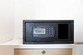 Small black safe in the wardrobe at the hotel room Royalty Free Stock Photo