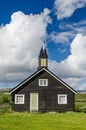 Small black wooden church on green hills Norway tundra Royalty Free Stock Photo