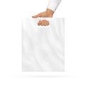 Small blank plastic bag mock up holding in hand. Royalty Free Stock Photo