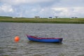 Small Boat Moored To Buoy On Lake