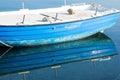 Small Blue Boat Reflected in Water Royalty Free Stock Photo