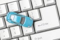 Small blue car on the computer keyboard Royalty Free Stock Photo