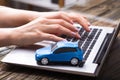 Small Blue Car On Laptop Keypad Royalty Free Stock Photo