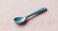A small blue ceramic spoon rests Royalty Free Stock Photo