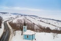 Small blue chapel with snow