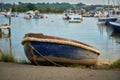 Small blue dinghy in Bembridge Harbour on the Isle of Wight Royalty Free Stock Photo