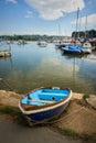 Small blue dinghy in Bembridge Harbour on the Isle of Wight, vertical Royalty Free Stock Photo
