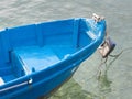 Small blue fishing boat docked in the harbor. Royalty Free Stock Photo