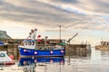 Small blue fishing vessel inside Gardenstown Harbour