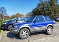 Old small blue grey 4WD car Toyota RAV4 parked