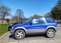 Old small blue grey 4WD car Toyota RAV4 parked