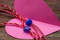 Small blue heart and star on red and white bakers twine with pink paper heart/International woman`s day card concept Royalty Free Stock Photo