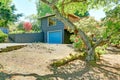 Small blue house with garage and large front yard with trees, Royalty Free Stock Photo
