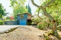 Small blue house with garage and large front yard with trees, Royalty Free Stock Photo