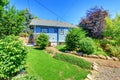 Small blue house with garden in back yard. Royalty Free Stock Photo