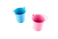 Small blue and pink buckets. Isolated on white background Royalty Free Stock Photo