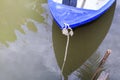 Small blue plastic rowboat on the water Royalty Free Stock Photo