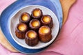 A small blue plate of CanelÃÂ©s de Bordeaux