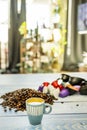 A small blue porcelain espresso cup on a table full of coffee beans and pods near the window Royalty Free Stock Photo