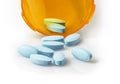 Small blue tablets spilling out of prescription container - straight on Royalty Free Stock Photo