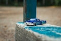 Small blue toy pickup truck on old concrete