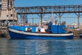 Small blue trawler boat standing by the pier Royalty Free Stock Photo