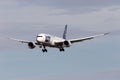 Small blue and white airplane Lot Polish Airlines landing at Krakow Airport