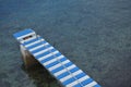 Small blue white sea dock to tie down the boats Royalty Free Stock Photo