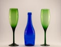 Small blue wine bottle and two green glasses Royalty Free Stock Photo