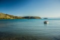 Small boat in Aegean sea bay beautiful peaceful evening twilight landscape with calm water surface and clear weather time Royalty Free Stock Photo